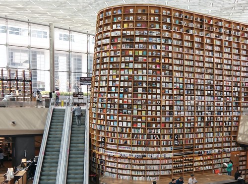 Image of a library entrance featuring an enormous display of shelved books